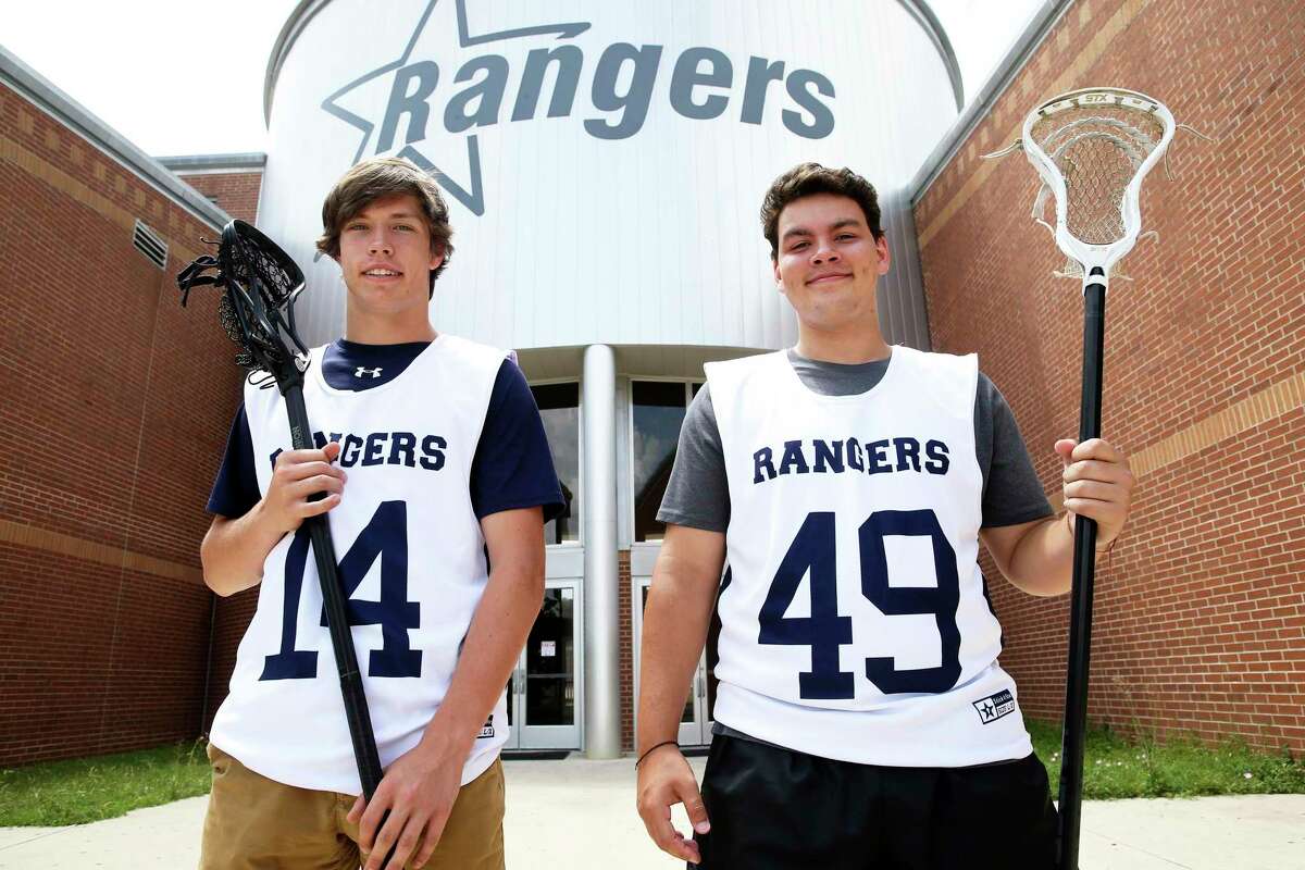 Will Ford, left, and Conner Cuellar stand with their lacrosse equipment at Smithson Valley High School on July 12, 2019.
