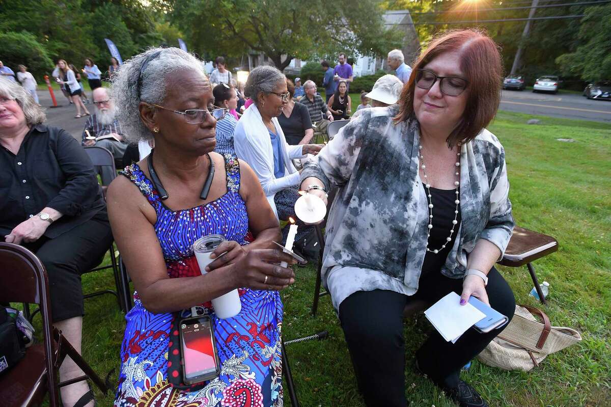 Gwendolyn Grimes of Bridgeport and Rev. ReBecca Sala, a board member of the Interfaith Council Southwest Connecticut join with others as they light candles during a Lights for Liberty vigil at the North Stamford Community Church in North Stamford, Conn. on July 12, 2019. The small rally attended by 100 local residents joined with over 1000 other protest across the U.S. calling for the stopping of injustice and the inhumane conditions faced by immigrants being held at detention camps.