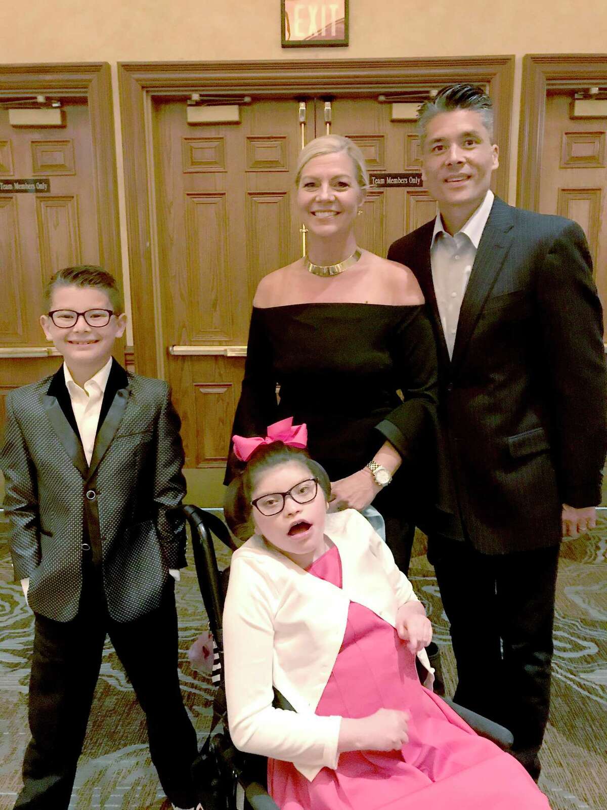 Mike Peck (right) poses for a photo with his wife Terri, son Gavin (left), and daughter Madi (front).