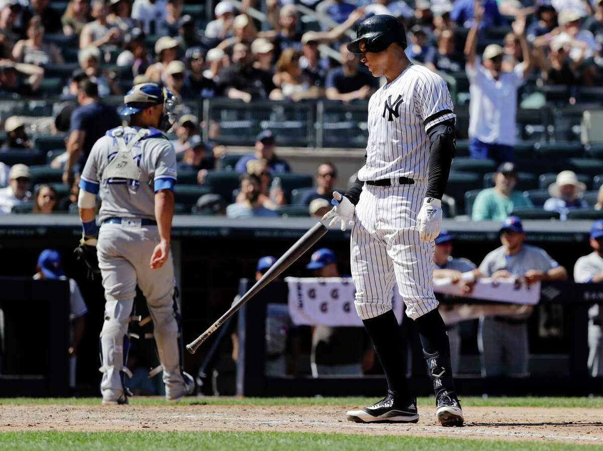 New York Yankees' Aaron Judge, right, reacts after striking out as Toronto Blue Jays catcher Luke Maile, left, heads back to the dugout after the seventh inning of a baseball game Saturday, July 13, 2019, in New York. The Blue Jays won 2-1.(AP Photo/Frank Franklin II)