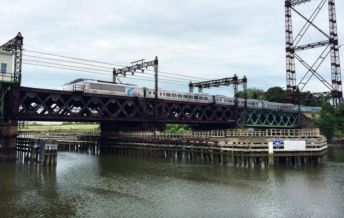 FILE - In this June 20, 2018 file photo, Amtrak's Acela Express crosses the Norwalk River Railroad Bridge, also known as the Walk Bridge, in Norwalk, Conn.
