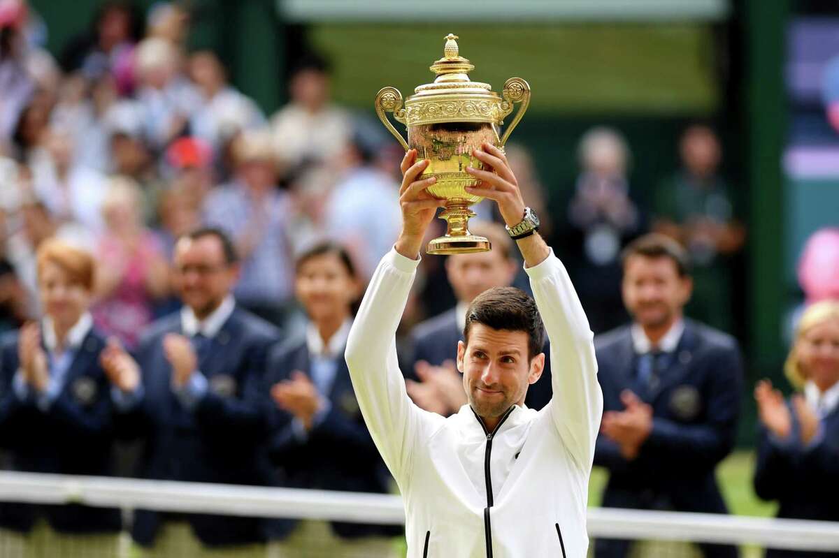 LONDON, ENGLAND - JULY 14: Novak Djokovic of Serbia lifts the trophy after winning his Men's Singles final against Roger Federer of Switzerland during Day thirteen of The Championships - Wimbledon 2019 at All England Lawn Tennis and Croquet Club on July 14, 2019 in London, England.