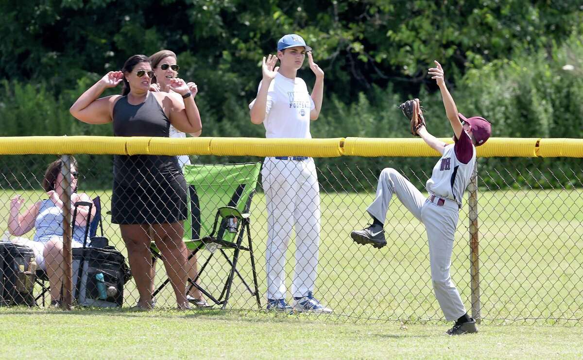 North Haven centerfielder Chris Kottage catches a fly ball at the fence against Milford in the District 4 Little League championship game in West Haven on Sunday.
