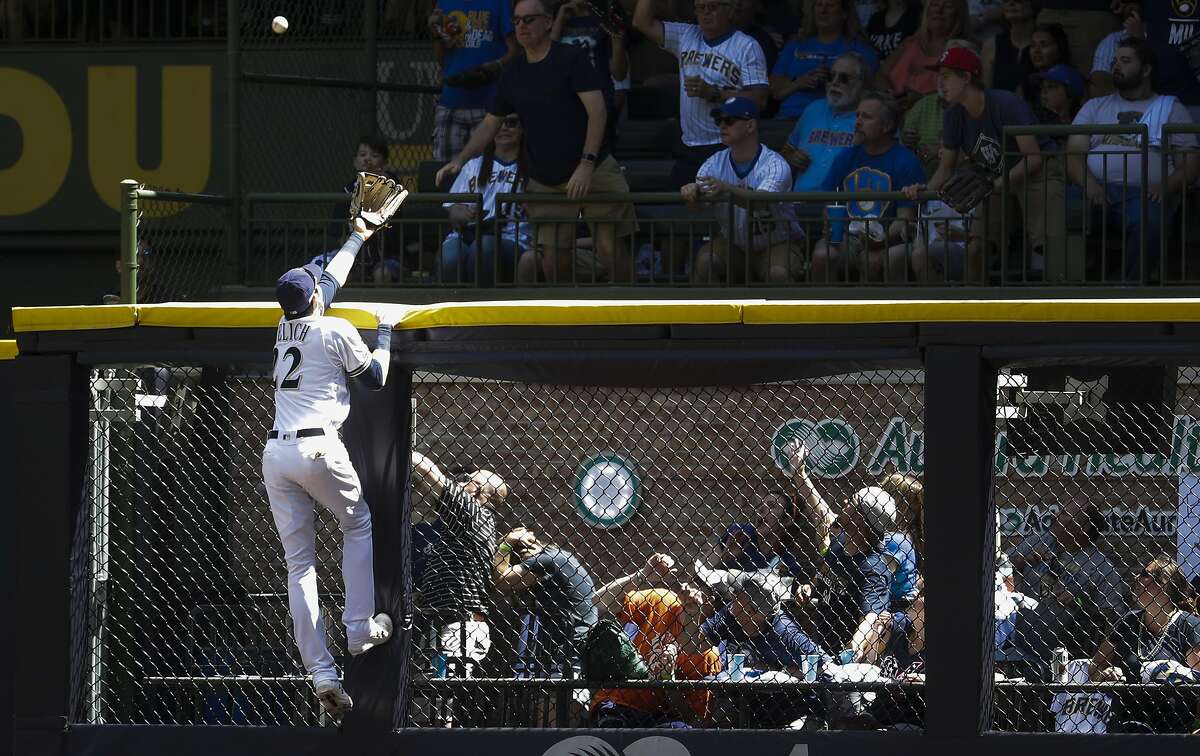 Milwaukee Brewers right fielder Christian Yelich can't catch a home run hit by San Francisco Giants' Brandon Belt during the fifth inning of a baseball game Sunday, July 14, 2019, in Milwaukee. (AP Photo/Morry Gash)