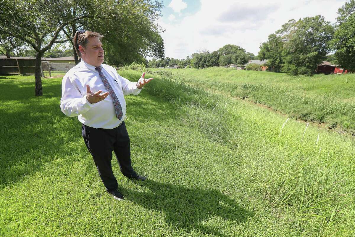 Bob McGrew talks about the proposed change to mercury testing of Berry Bayou that runs through the back of his property Tuesday, July 9, 2019, in Houston.