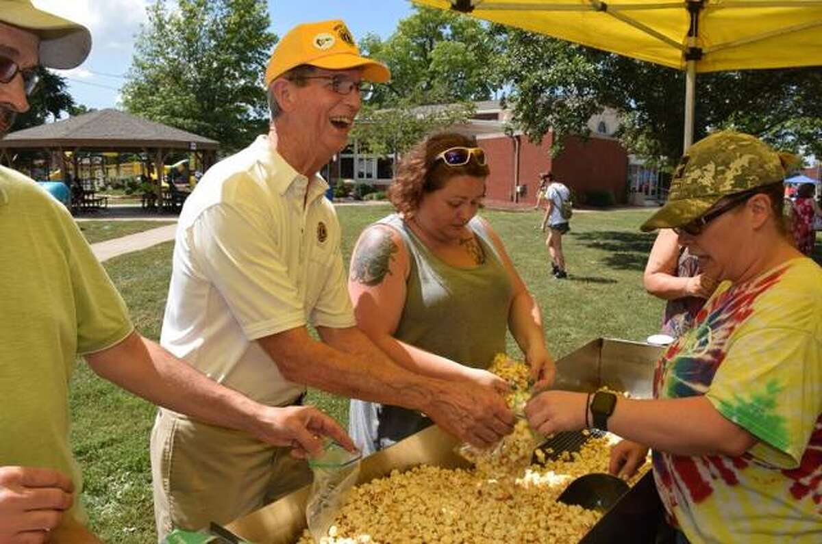 Wood River Lions Club members bag popcorn to be enjoyed by ice cream social visitors on Sunday.