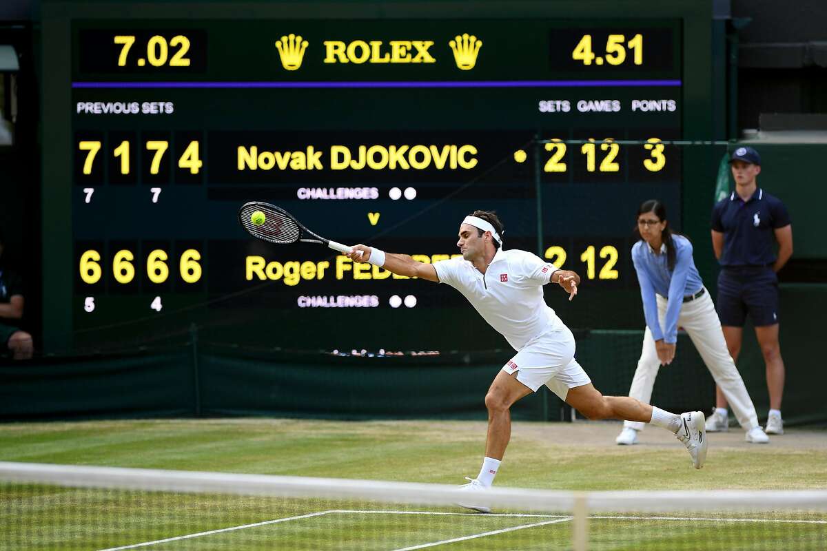 LONDON, ENGLAND - JULY 14: The scoreboard is seen as Roger Federer of Switzerland plays a forehand in the final set in the Men's Singles final between Novak Djokovic of Serbia and Roger Federer of Switzerland during Day thirteen of The Championships - Wimbledon 2019 at All England Lawn Tennis and Croquet Club on July 14, 2019 in London, England. (Photo by Matthias Hangst/Getty Images)