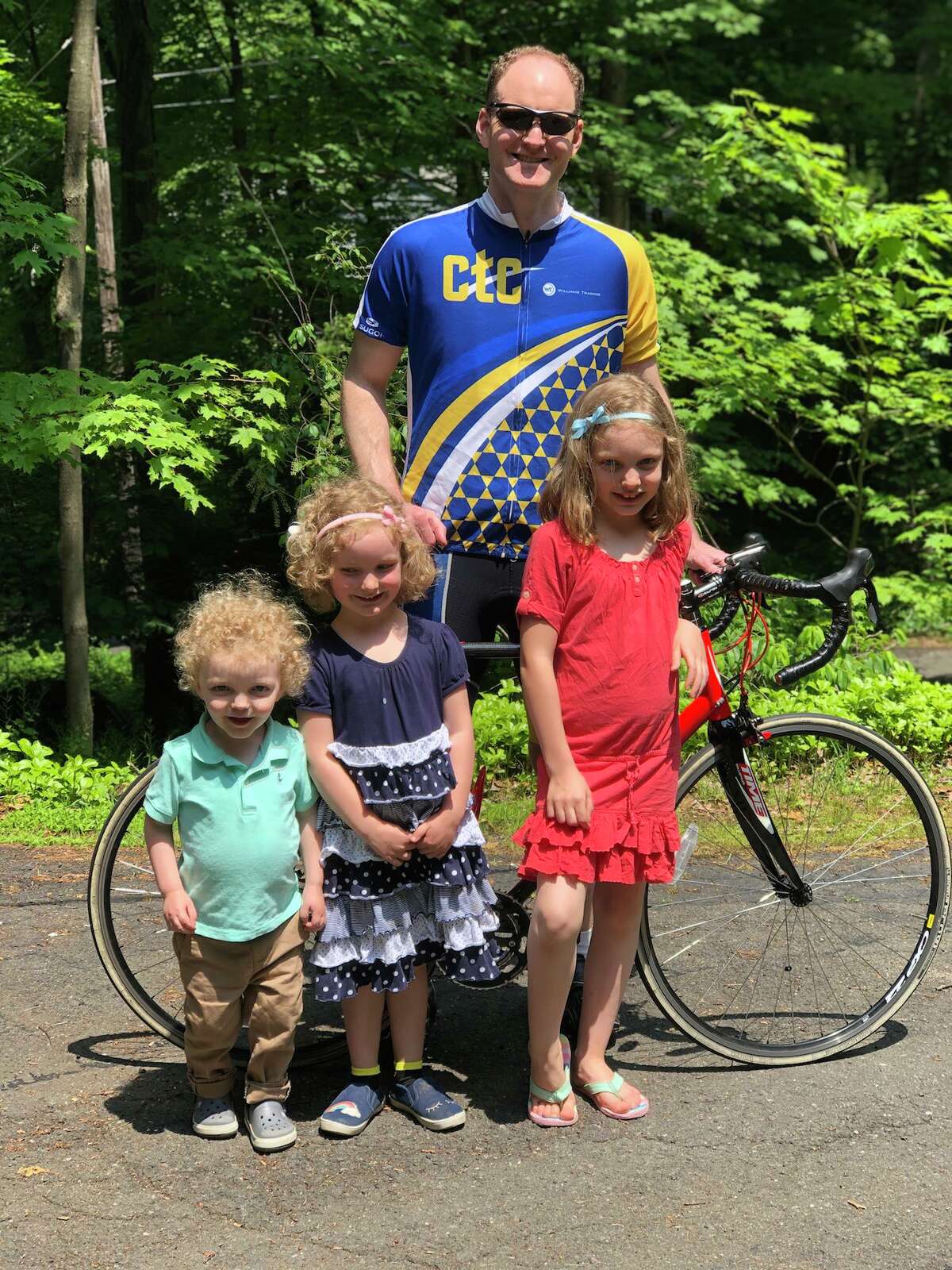 Ridgefielder Paul Fitzpatrick with his three children. On July 27, he will cycle 100 miles to raise $10,000 for the CT Challenge — a nonprofit organization dedicated to helping the 15.5 million cancer survivors in Connecticut and throughout the U.S.