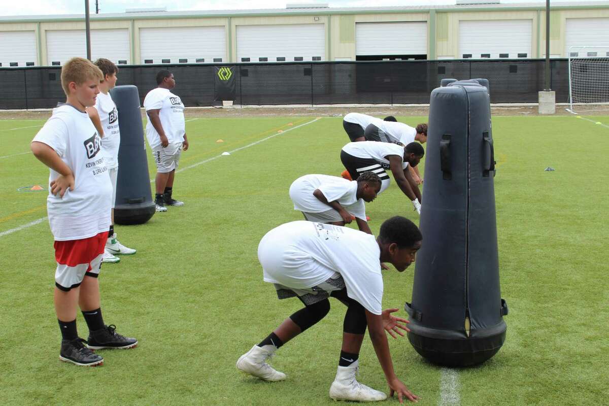 Youth camp participants work on their stance during the B.GR8 Lineman Camp for Houston youth football players at Ollin Athletics and Sports Medicine in Cypress on July 13, 2019.