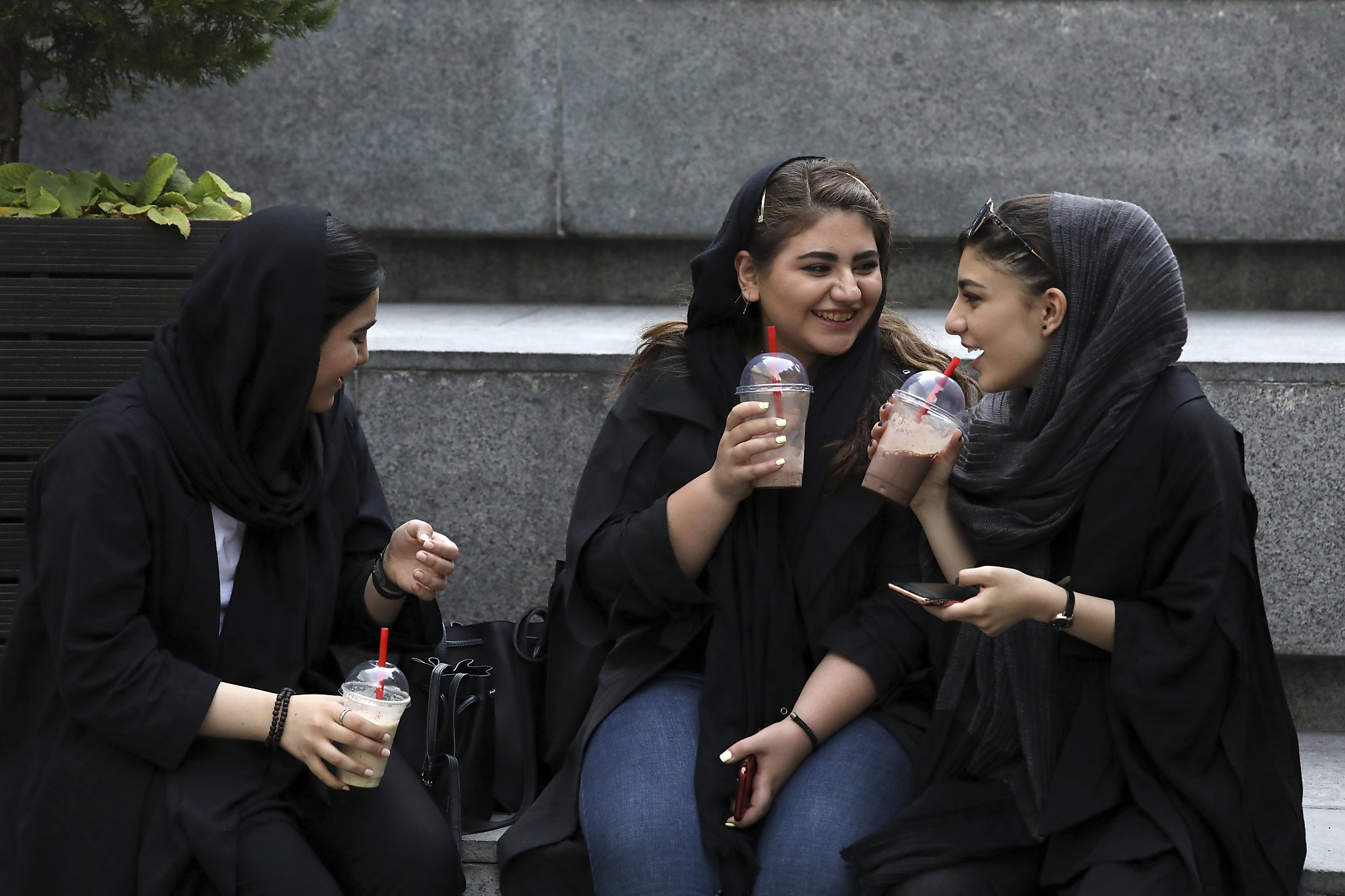 Some Iranian women take off hijabs as hard-liners push back.