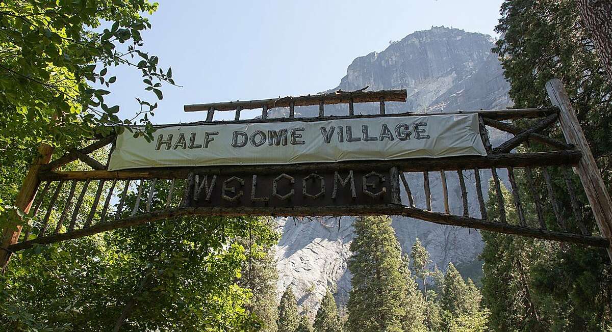 A sheet of plastic covers the original sign for Camp Curry Village in Yosemite National Park.