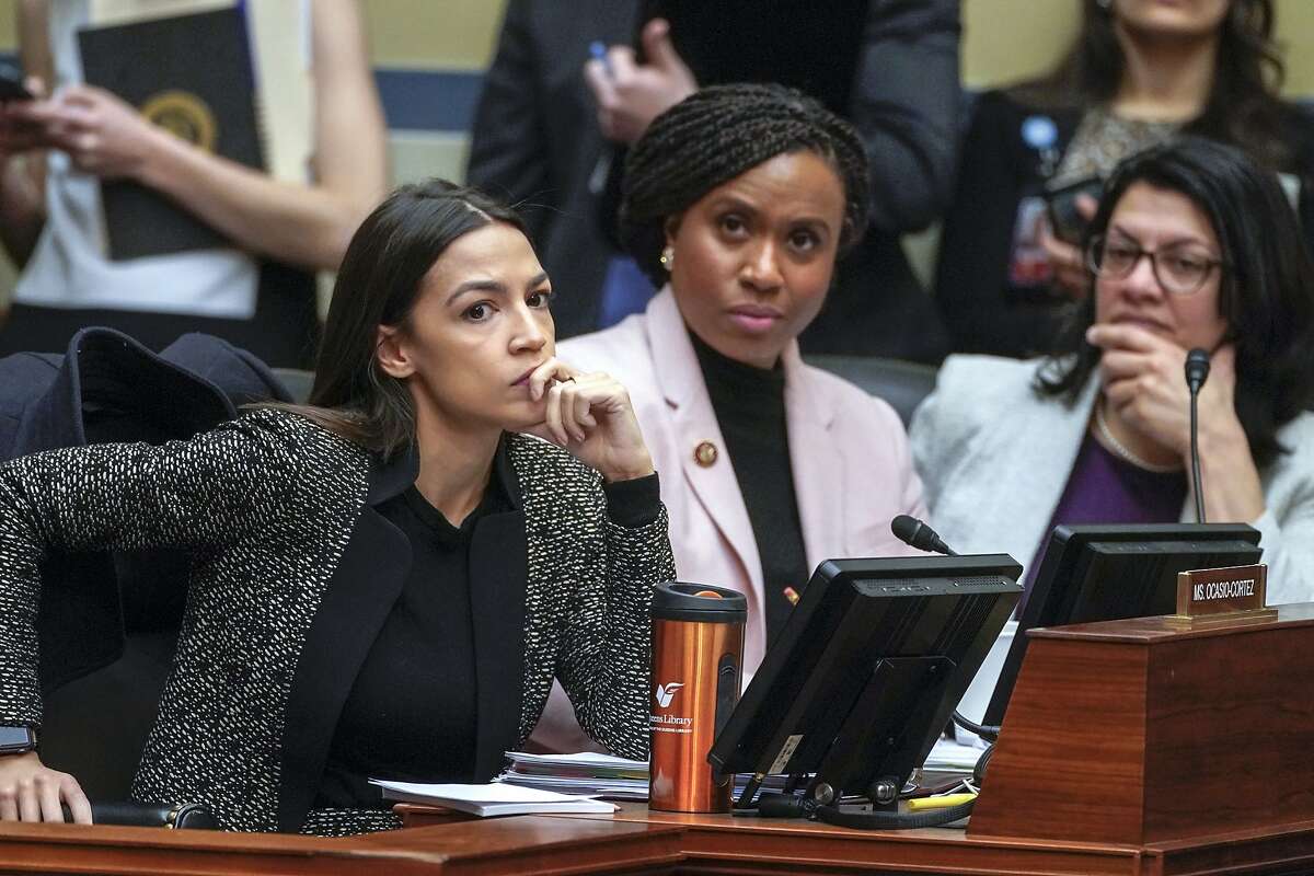 Rep. Alexandria Ocasio-Cortez, D-N.Y., left, joined by Rep. Ayanna Pressley, D-Mass., and Rep. Rashida Tlaib, D-Mich., listens during a House Oversight and Reform Committee meeting Feb. 26, 2019, on Capitol Hill in Washington.