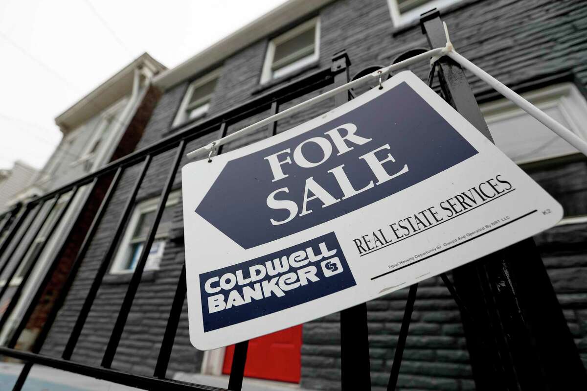 FILE- In this Jan. 4, 2019, file photo a sign hangs outside a house for sale in Pittsburgh's Lawrenceville neighborhood. U.S. home sales slipped 0.4% in April 2019, as would-be homebuyers face affordability challenges and a limited supply of starter houses. The National Association of Realtors says that existing homes sold at a seasonally adjusted annual rate of 5.19 million last month, down from 5.21 million in March 2019. (AP Photo/Keith Srakocic, File)