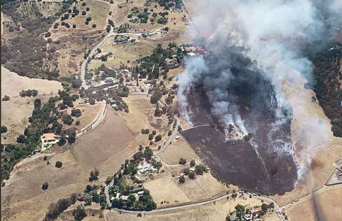 A brush fire broke out in East San Jose on Monday, July 15, 2019 threatening nearby structures, authorities said.