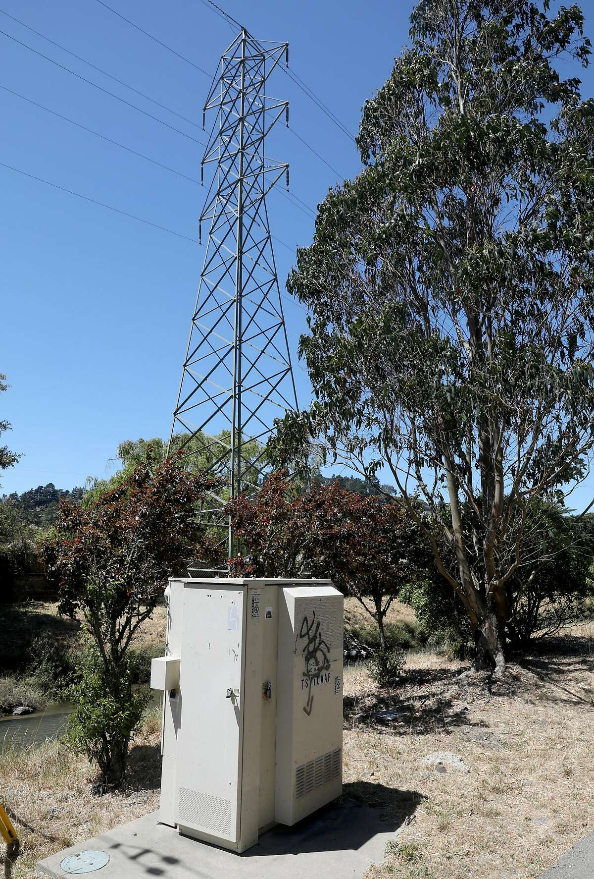 Marin power line seen behind a ATT underground power line at Tennessee Valley Rd. @ Marin Ave. next to the Charles F. McGlashan multiuse pathway on Monday, July 15, 2019 in Mill Valley, Calif.