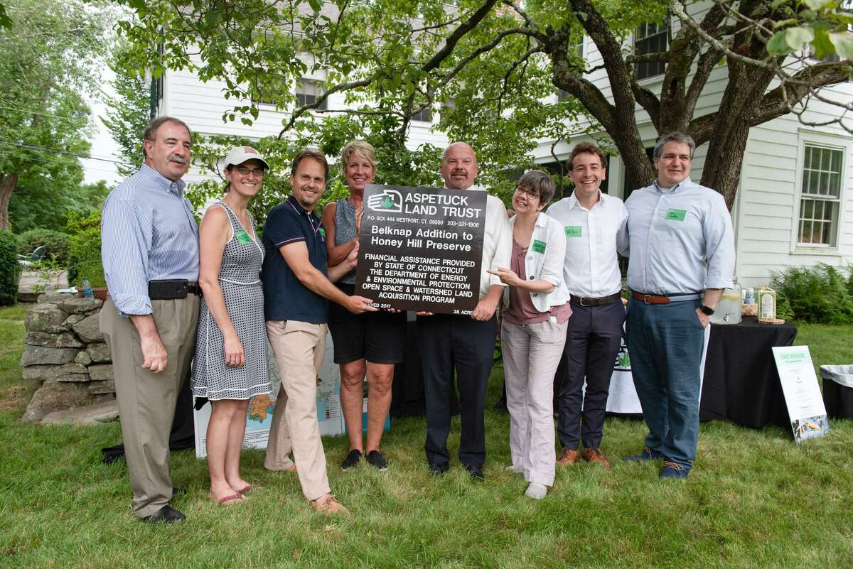 The Aspetuck Land Trust presents a new sign for its Honey Hill preserve on the Weston-Wilton town line calling attention to the 38-acre Belknap Addition, adding to the preserve trail network and forest and wetland preservation area. From left are: State Rep. Jonathan Steinberg (D-136 District - Westport), State Rep. Cristin McCarthy Vahey (D-133 District - Fairfield), Dave Brant, executive director of the Aspetuck Land Trust, State Rep. Laura Devlin (D-134 District - Fairfield), State Rep. Joseph Gresko (D-121 District - Stratford), State Rep. Ann Hughes (D-135 District Easton, Redding, Weston), State Sen. Will Haskell (D-26 District - Bethel, New Canaan, Redding, Ridgefield, Weston, Westport, Wilton) and First Selectman Christopher Spaulding (D-Weston)