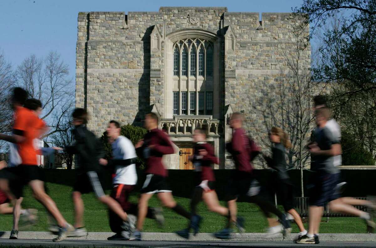 Runners run past Norris Hall at the start of a 3.2 mile run in honor of the 32 victims of the April 16, 2007 shootings at Virginia Tech on the campus of the school in Blacksburg, Va., Thursday, April 16, 2009. The run marked the start of the second anniversary activities. (AP Photo/Steve Helber)