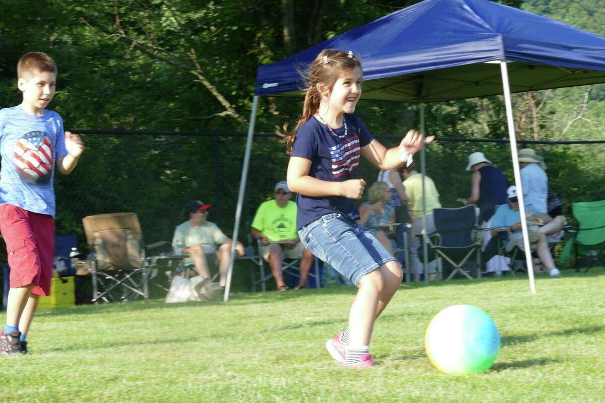 Katia kicks a ball during the town's annual Fourth of July celebration at Ridgefield High School last week.