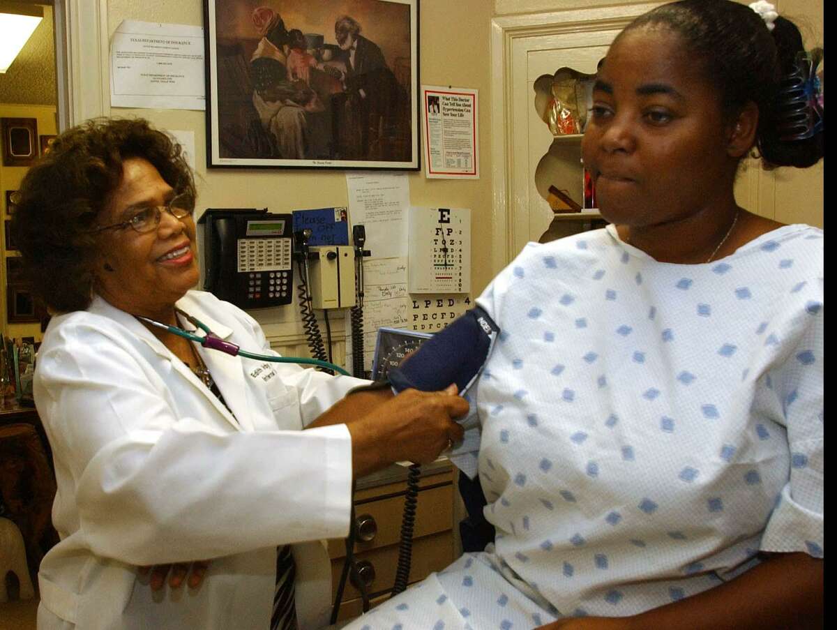 Dr. Edith Irby Jones, 74 at the time, takes Janice Crawford’s blood pressure in her office on Prospect, in this Sept. 6, 2001, file photo. Jones, who made a promise at 7 years old to serve the poor, has taken items like eggs, fresh vegetables and dollar bills as payment for her services.