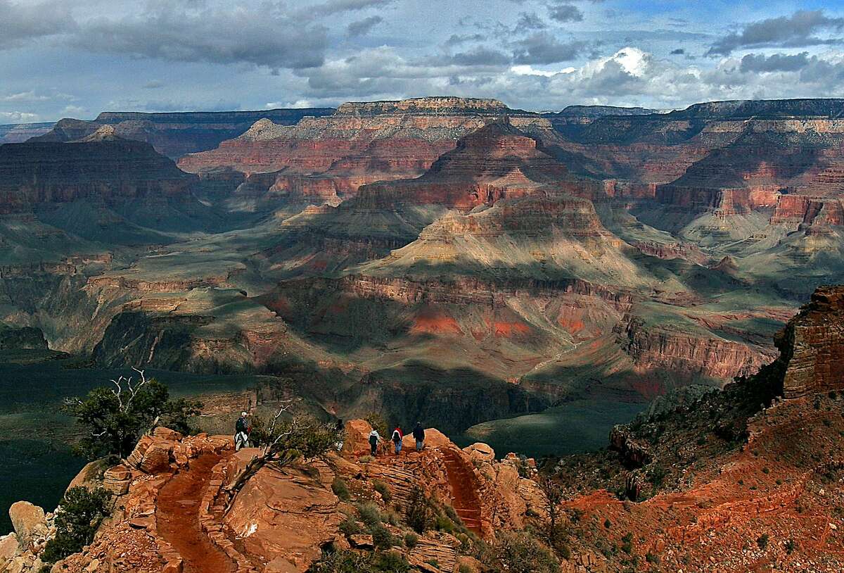 FILE -- With the North Rim in the background, tourists hike along the South Rim of the Grand Canyon in this Feb. 22, 2005 file photo in Grand Canyon, Ariz. . (AP Photo/Rick Hossman, File)
