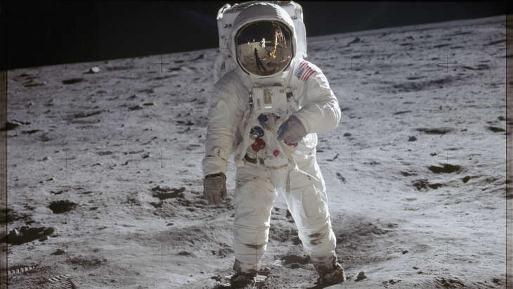 Astronaut Buzz Aldrin is photographed on the surface of the moon. Fellow astronaut Neil Armstrong, who took the photo, is reflected in Aldrin’s visor.