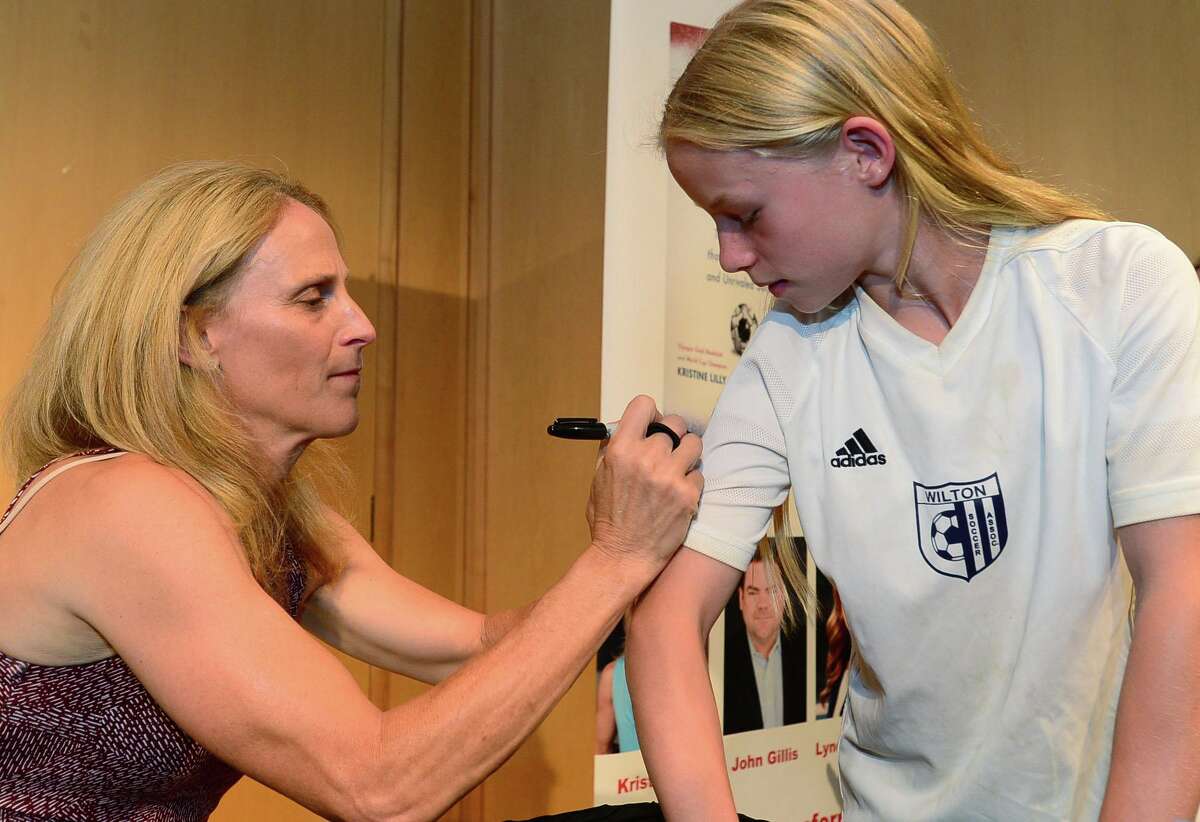 Wilton resident and soccer player Rose Mallory, 10, gets her books signed after Wilton High School graduate and soccer star Kristine Lilly spoke Tuesday, July 16, 2019, at Wilton Library in promotion of her new book, PowerHouse, in Wilton, Conn.