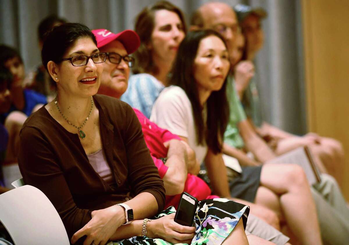 Audience members listen as Wilton High School graduate and soccer star Kristine Lilly speaks Tuesday, July 16, 2019, at Wilton Library in promotion of her new book, PowerHouse, in Wilton, Conn.
