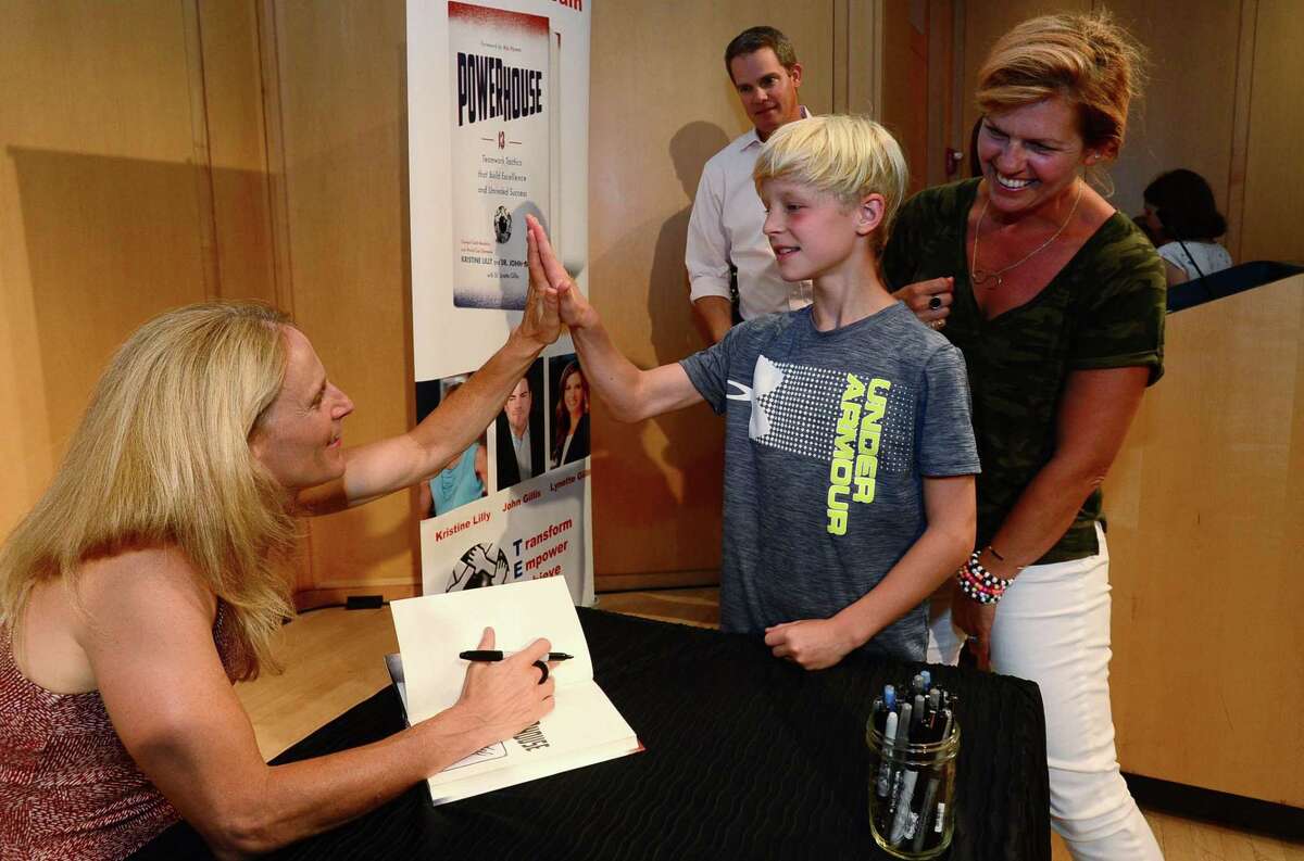 Attendees get heir books signed after Wilton High School graduate and soccer star Kristine Lilly spokeTuesday, July 16, 2019, at Wilton Library in promotion of her new book, PowerHouse, in Wilton, Conn.