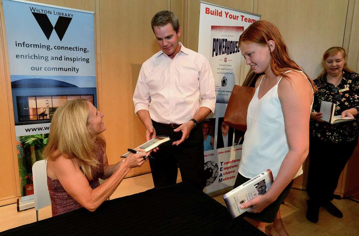 Attendees get heir books signed after Wilton High School graduate and soccer star Kristine Lilly spokeTuesday, July 16, 2019, at Wilton Library in promotion of her new book, PowerHouse, in Wilton, Conn.