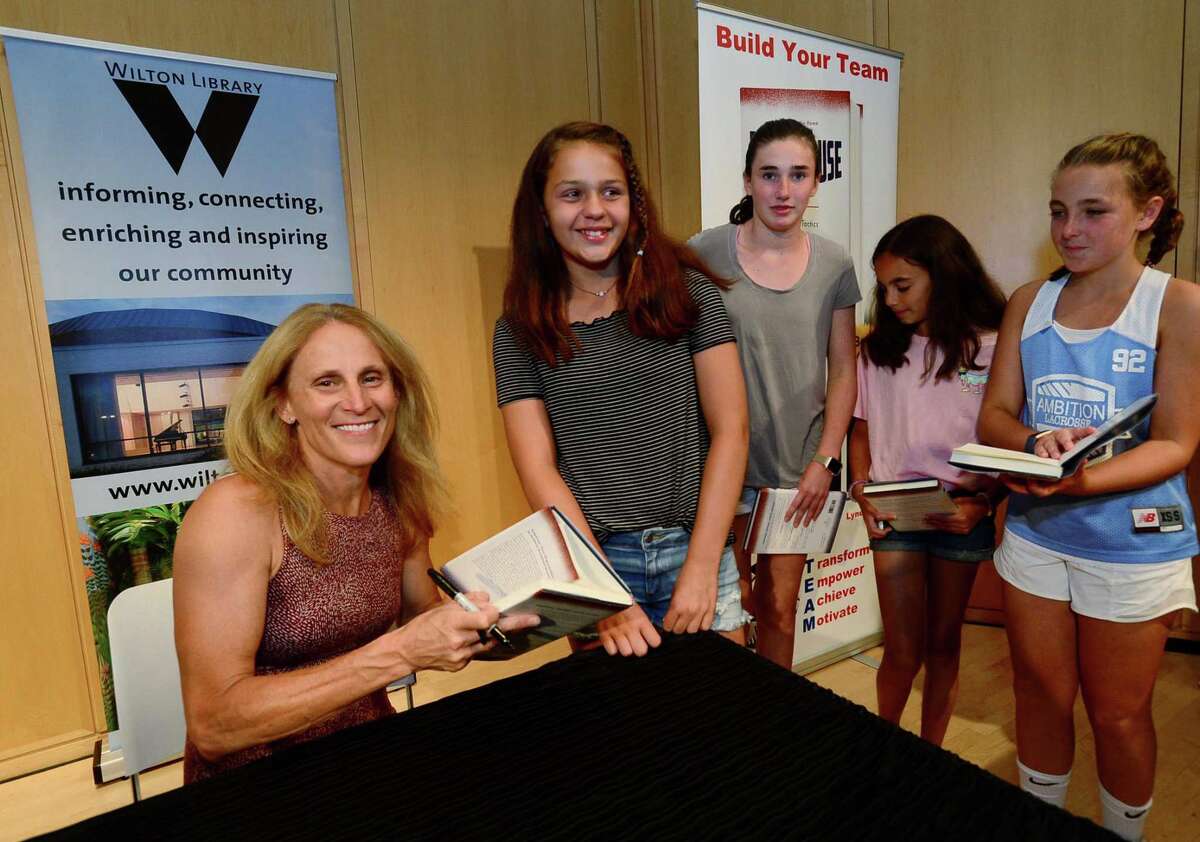 Attendees get heir books signed after Wilton High School graduate and soccer star Kristine Lilly spokeTuesday, July 16, 2019, at Wilton Library in promotion of her new book, PowerHouse, in Wilton, Conn.
