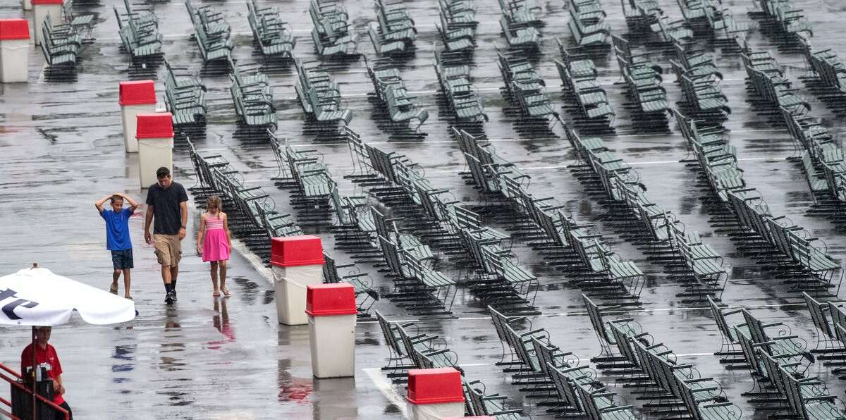 Race fans walk the track apron on Wednesday, July 17, 2019, at Saratoga Race Course. Rain canceled the first race and moved all turf races to the dirt track. (Skip Dickstein)
