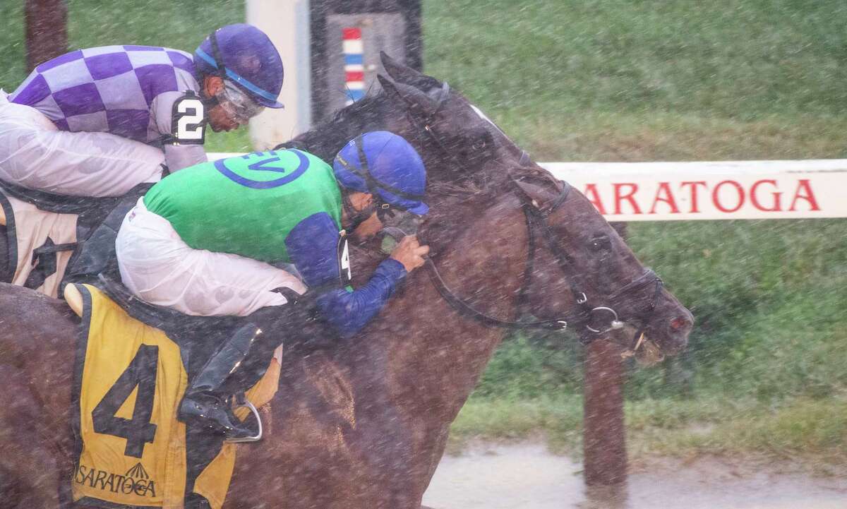 In a downpour Sky of Hook ridden by Luis Saez noses out Listentoyourheart ridden by Manuel Franco at the wire to win the 6th running of The Rick Violette at the Saratoga Race Course Wednesday July 17 2019 in Saratoga Springs, N.Y. Special to the Times Union by Skip Dickstein