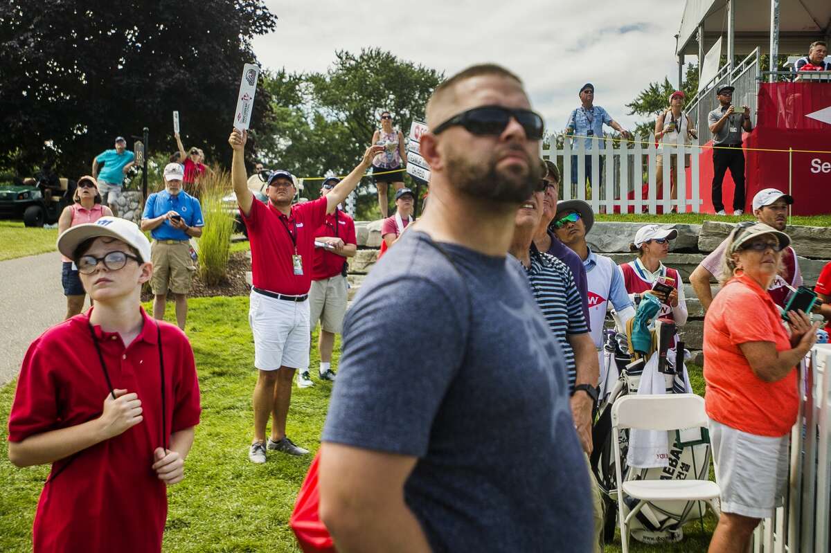 A volunteer holds up a "Quiet" sign during the Dow Great Lakes Bay Invitational on Wednesday, July 17, 2019 at Midland Country Club. (Katy Kildee/kkildee@mdn.net)