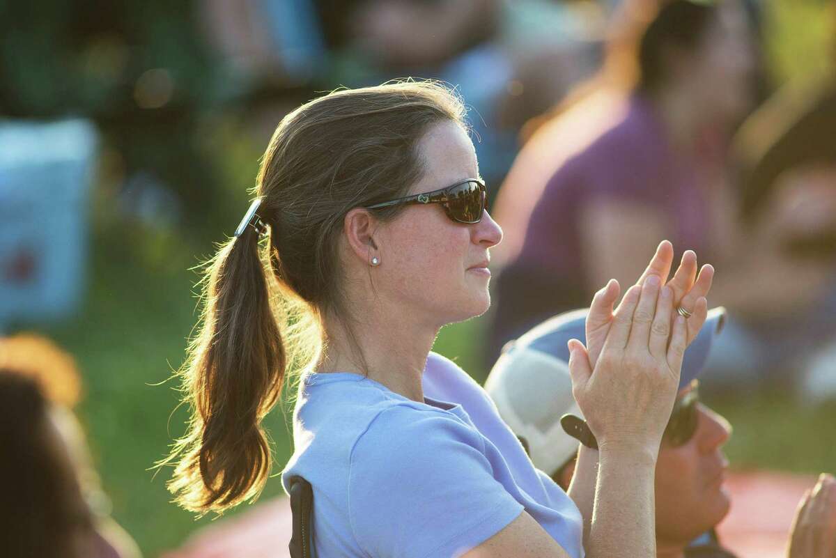 An audience member claps at the Valley Shakespeare Festival’s performance of King Henry VIII at the Veterans Memorial Riverwalk Park in Shelton, Connecticut on Sunday, July 14, 2019 The Valley Shakespeare Festival performed King Henry VIII on Sunday, July 14, 2019 at the Veterans Memorial RIverwalk in Shelton, Connecticut.