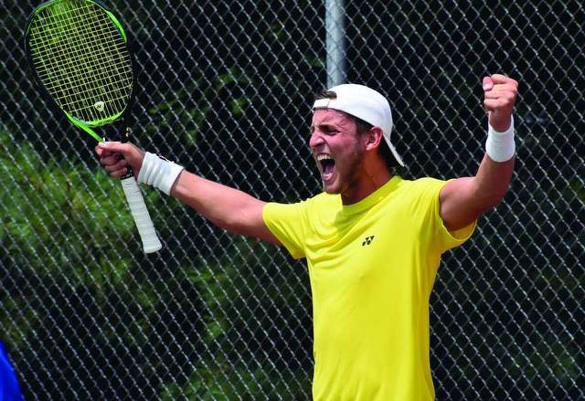 Axel Geller celebrates after winning the USTA Edwardsville Futures in a three-set tiebreaker on Sunday at the EHS Tennis Center. It was the first Futures championship for Geller, who is from Buenos Aires, Argentina.
