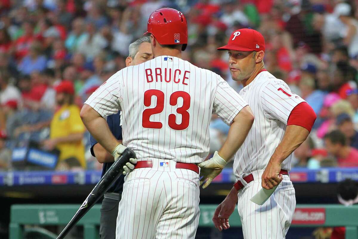 PHILADELPHIA, PA - JULY 16: Jay Bruce #23 of the Philadelphia Phillies is is looked at by a member of the medical staff and manager Gabe Kapler #19 after injuring himself on a swing against the Los Angeles Dodgers during the third inning of a baseball game at Citizens Bank Park on July 16, 2019 in Philadelphia, Pennsylvania. Bruce left the game in the middle of his at-bat. (Photo by Rich Schultz/Getty Images)