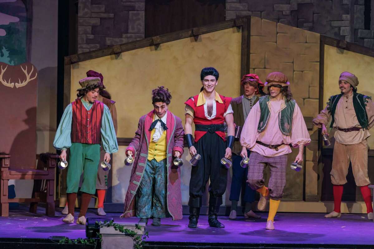 Michael Parisi and Cary Farrow IV, center, play Lefou and Gaston, respectively, in the Woodlawn Theatre's staging of "Beauty and the Beast." The musical is based on the animated movie.