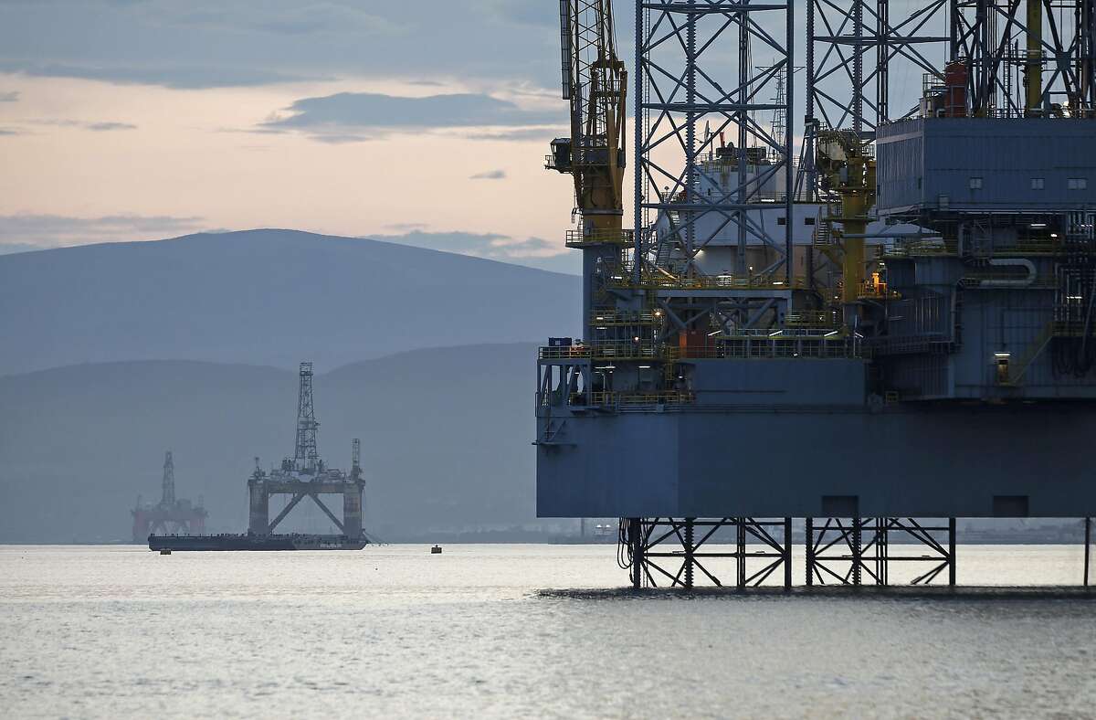 Offshore drilling rigs Ocean Vanguard, operated by Diamond Offshore Drilling Inc., left, J. W. McLean, operated by Transocean Ltd., center, and Prospector 1, operated by Prospector Offshore Drilling SA, right, stand anchored in the Cromarty Firth in Cromarty, U.K., on Tuesday, Aug. 5, 2014.