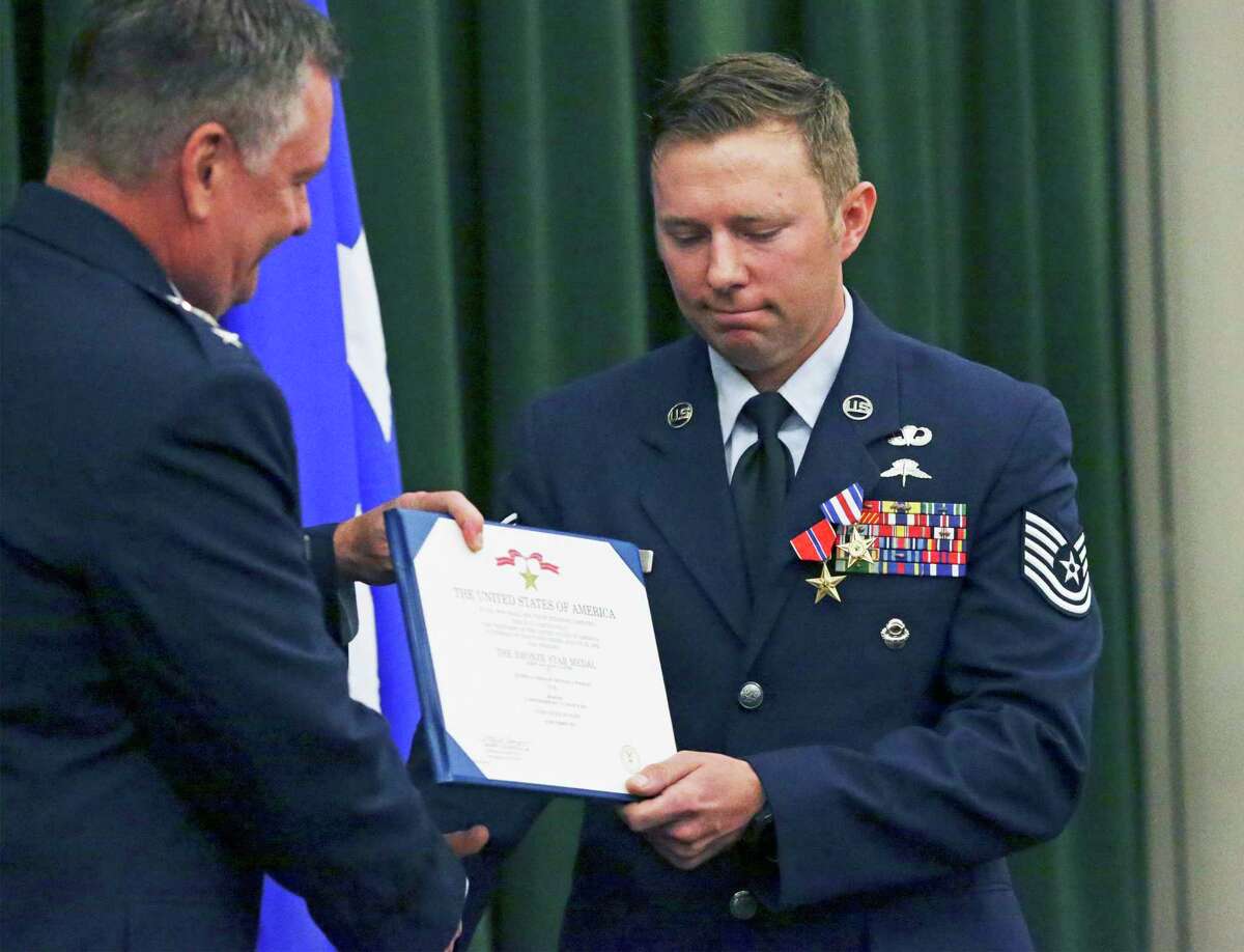 Tech. Sgt. Michael Perolio receives the Silver Star and Bronze Star awards for battlefield heroism from Lt. Gen. Marshall “Brad” Webb, the incoming head of the Air Education and Training Command, in a ceremony at Lackland AFB.