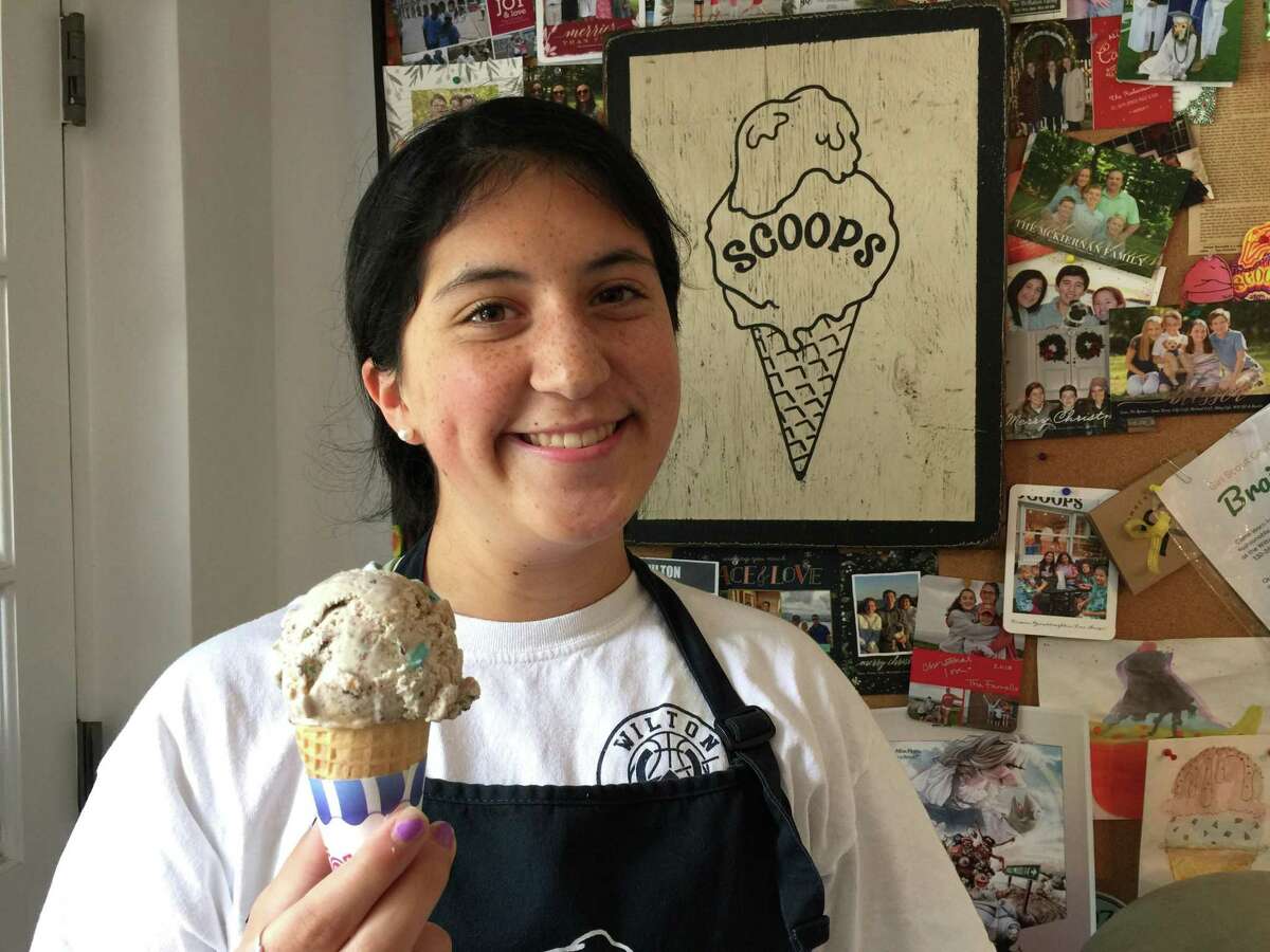 At Scoops in Wilton, Catalina King packs a cone of Swamp ice cream.