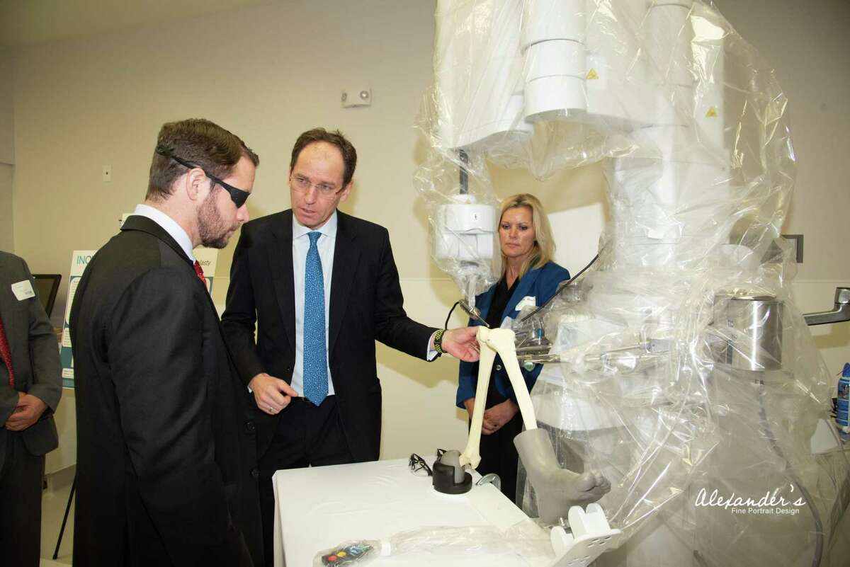 Dr. Stefan Kreuzer, center, gives a tour of the new surgical center that Inov8 Orthopedics opened in Houston on June 14, 2019. Kreuzer wants to bring down the cost joint replacement surgeries by using the latest technology, boosting efficiency and offering bundled pricing.