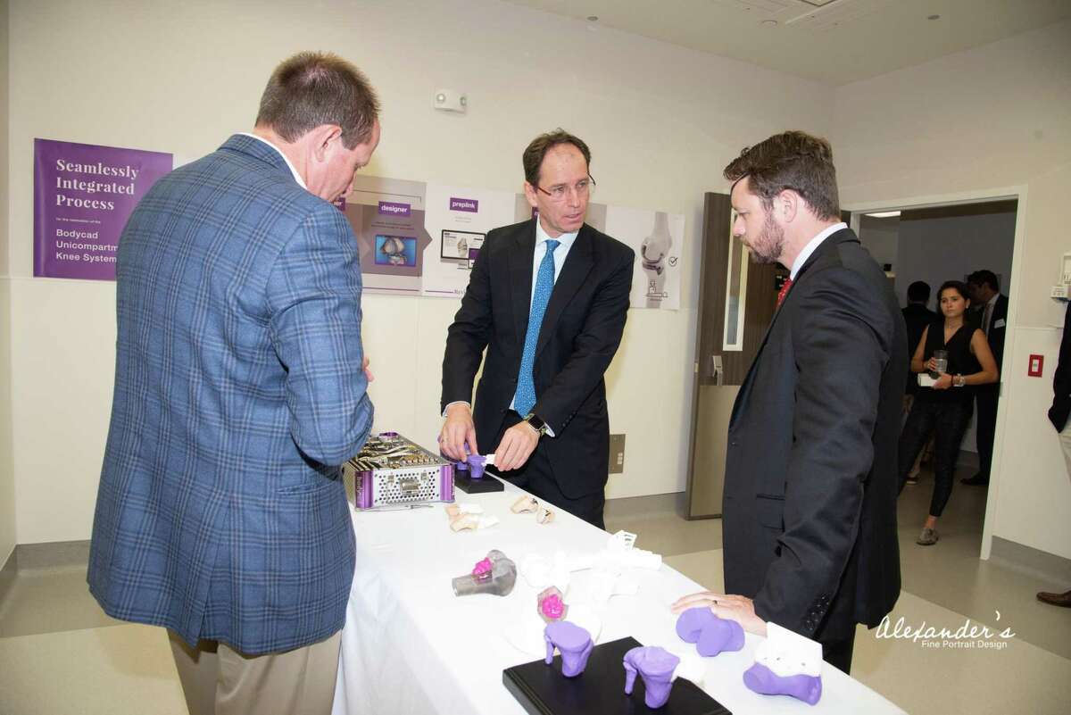Dr. Stefan Kreuzer, center, gives a tour of the new surgical center that Inov8 Orthopedics opened in Houston on June 14, 2019. Kreuzer wants to bring down the cost joint replacement surgeries by using the latest technology, boosting efficiency and offering bundled pricing.