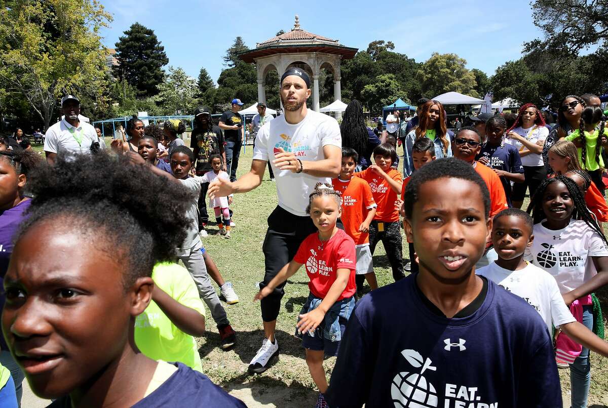Golden States Warriors guard Stephen Curry dances with his daughter Riley, who turns 7 this week, during the launch of Eat, Play, Learn, at Lakeside Park at Lake Merritt in Oakland, Calif., on Thursday, July 18, 2019. Curry and his wife Ayesha started the new foundation that focuses on providing support for the 3 basic ingredients of a healthy childhood. They are partnering with Oakland Parks and Recs and other local entities to provide services for underserved Oakland children.