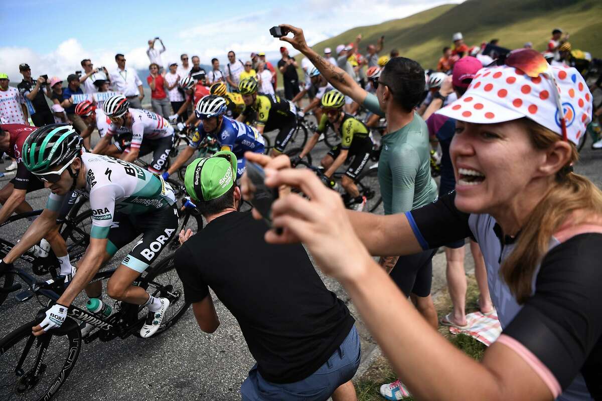 Cycling enthusiasts cheer riders in a curve uphill during the twelfth stage of the 106th edition of the Tour de France cycling race between Toulouse and Bagneres-de-Bigorre, on July 18, 2019. (Photo by JEFF PACHOUD / AFP)JEFF PACHOUD/AFP/Getty Images