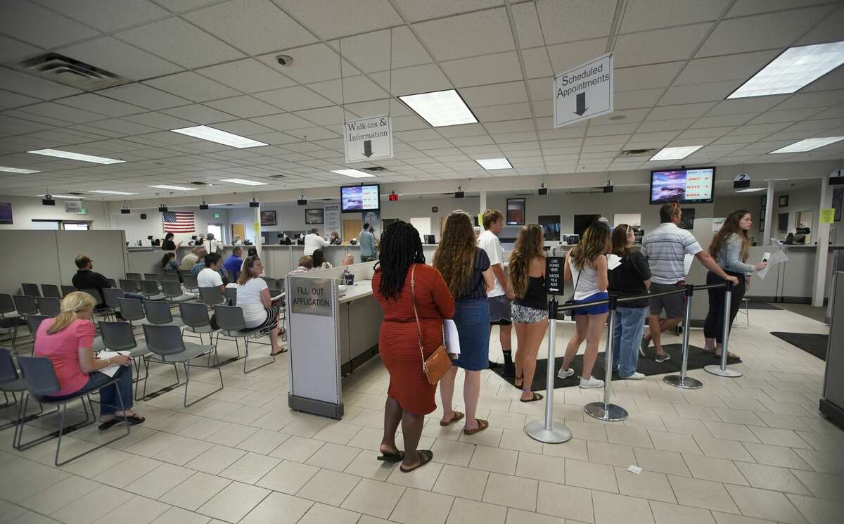 FILE — People wait in line at the Driver License Division for the state of Utah on July 9 in Orem, Utah.