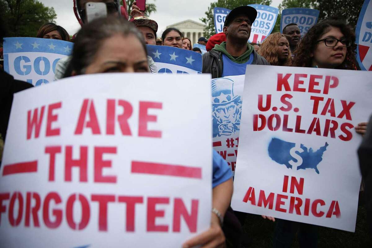 Minimum-wage activists hold signs during a rally in Washington in 2017.