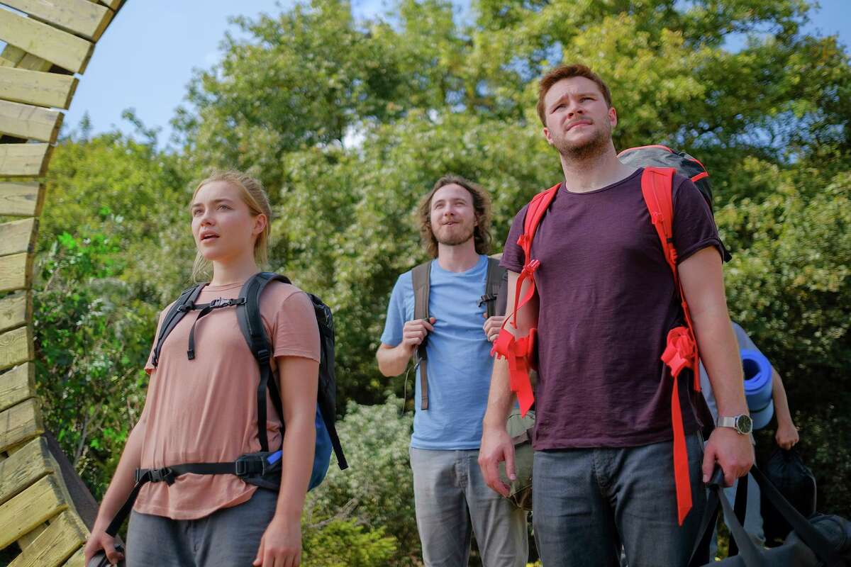 This image released by A24 shows Jack Reynor, right, and Florence Pugh in a scene from the horror film