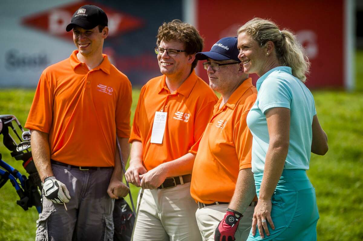 Suzann Pettersen of the LPGA, right, poses for a photo with, from left, Justin Doran, Nick Wagenmaker and Nick McCabe as they compete in the Special Olympics 3-Hole Challenge on Friday, July 19, 2019 at Midland Country Club. (Katy Kildee/kkildee@mdn.net)