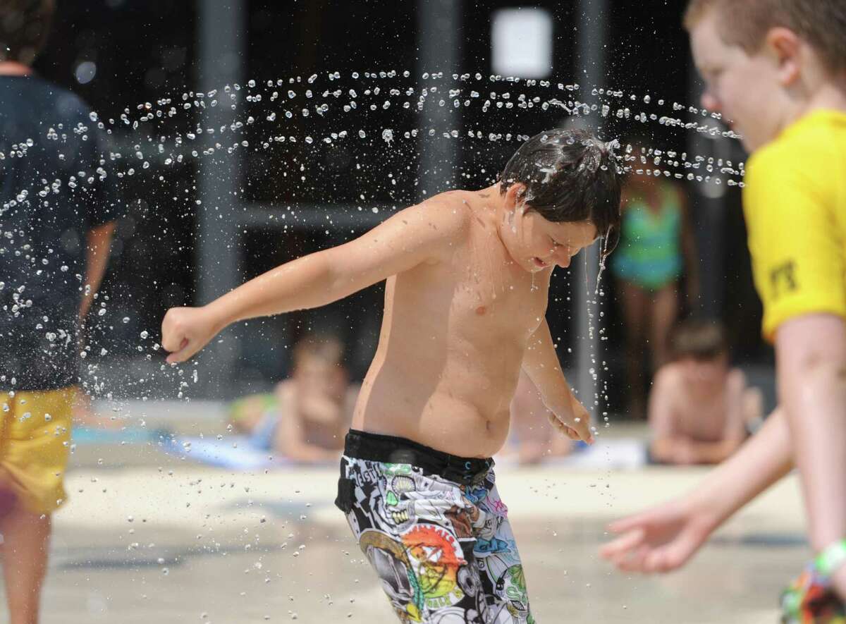 Edward Bergham, 10, of North Salem, N.Y., gets doused with a stream of water at the new Spray Bay at the Ridgefield Parks & Recreation Center in Ridgefield, Conn. Friday, Aug. 8, 2014. The 2,800 sqare foot water playground officially opened Saturday, Aug. 2. The Spray Bay is open Monday through Friday from 10 a.m. to 7 p.m., and Saturday and Sunday from 10 a.m. to 5:45 p.m. It is included with kids Adventure Day Camp and the Family Recreation or Family All-Inclusive memberships with a $10 drop-in rate for non-members.