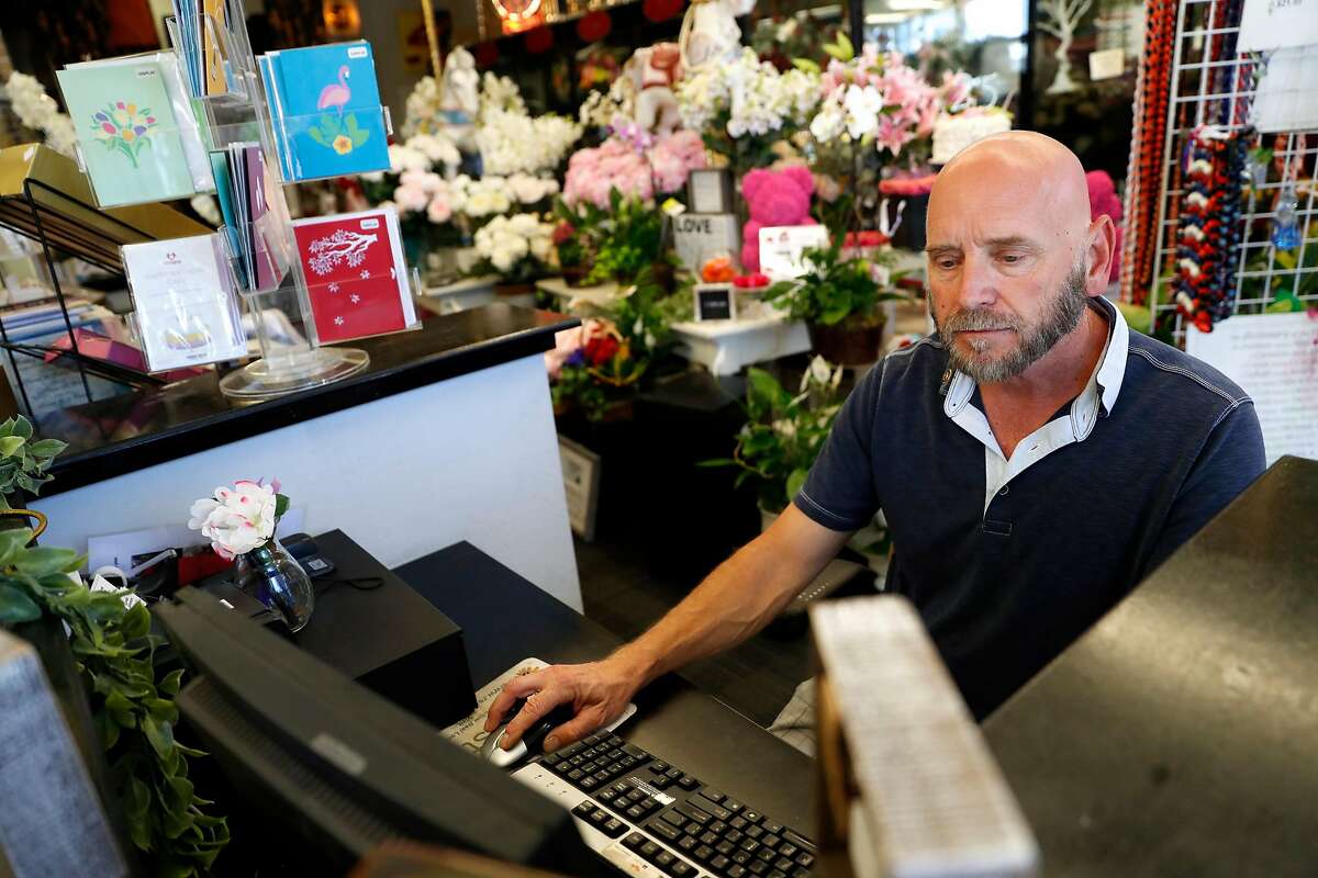 Fremont Flowers' Dirk Lorenz works on a computer at his store in Fremont, Calif., on Tuesday, July 16, 2019.